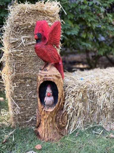 Cardinals in a new style — female perched in the stump hole, with her male counterpart / mate stretching his wings above. 36" tall, pine. Cardinals in stump, female perched and male stretching wings