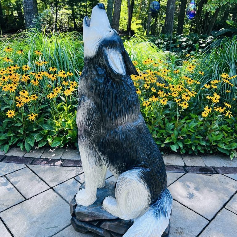 Commission carving — howling wolf, painted finish, on a stone base. Howling wolf carving, painted finish, on a stone base